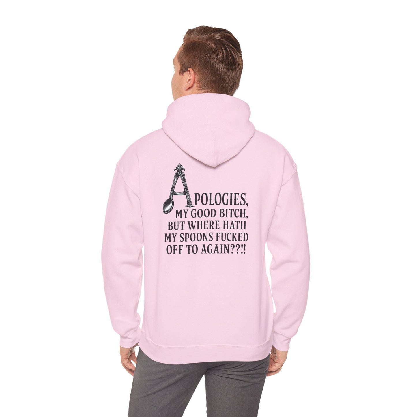 A man viewed from behind wearing a light pink hoodie with a black graphic and text on the back, paired with gray pants, against a plain white background.