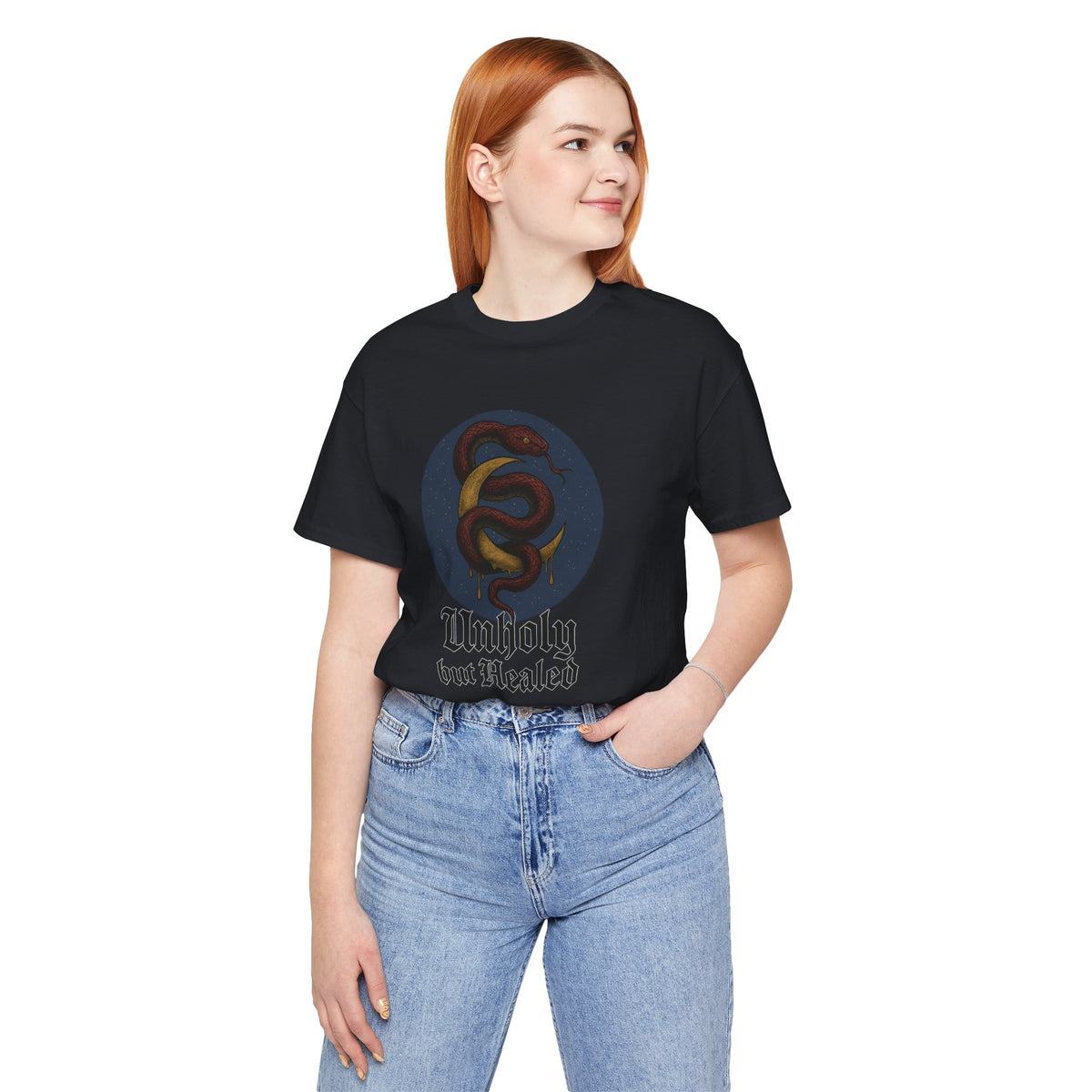 Vintage Black tee printed with a maroon snake coiled around a gold crescent moon, reading "Unholy but Healed".