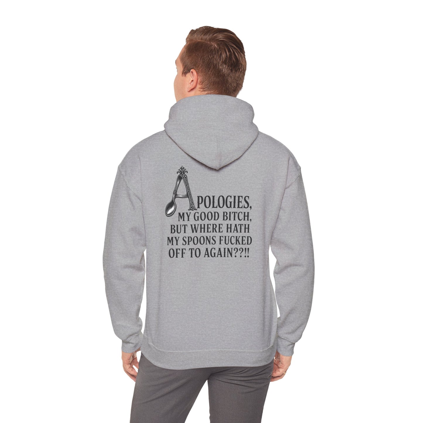 A man viewed from behind wearing a light grey pullover hoodie with a black graphic and text on the back, paired with gray pants.