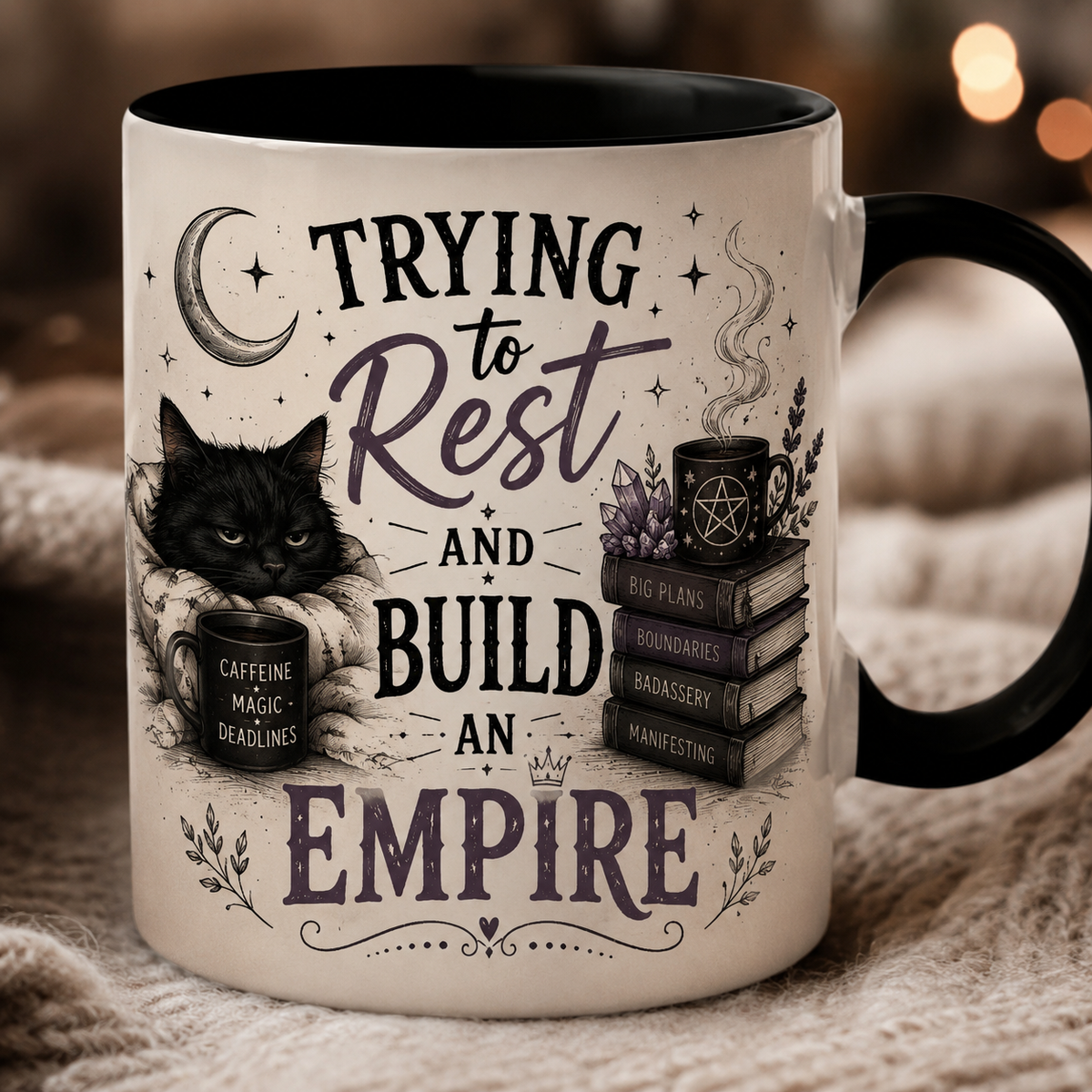 White mug with a black handle, printed with a black cat, a crescent moon, a mug reading "CAFFEINE MAGIC DEADLINES" and books titled "BIG PLANS", "BOUNDARIES", "BADASSERY" and "MANIFESTING", under "TRYING TO REST AND BUILD AN EMPIRE".