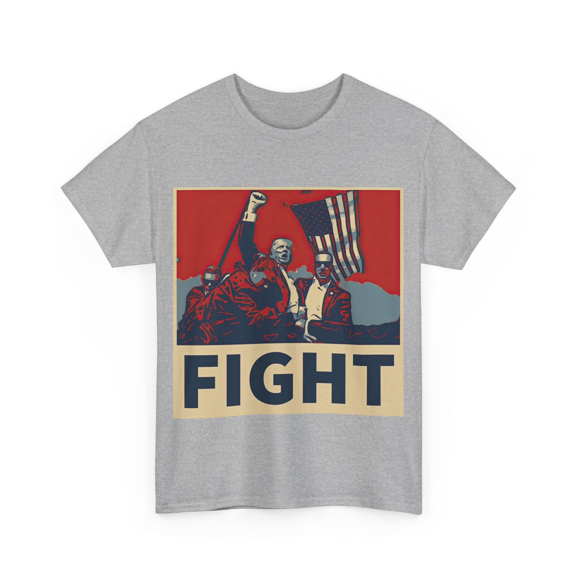 This image shows a light grey colored unisex heavy cotton t-shirt with a graphic design on the front. The design features a stylized, poster-like illustration of former President Donald Trump raising his fist and standing in front of an American flag. The word “FIGHT” is prominently displayed at the bottom of the illustration in bold capital letters. The graphic uses a color palette reminiscent of red, white, and blue, contributing to a patriotic theme. The t-shirt is displayed on a plain white background.