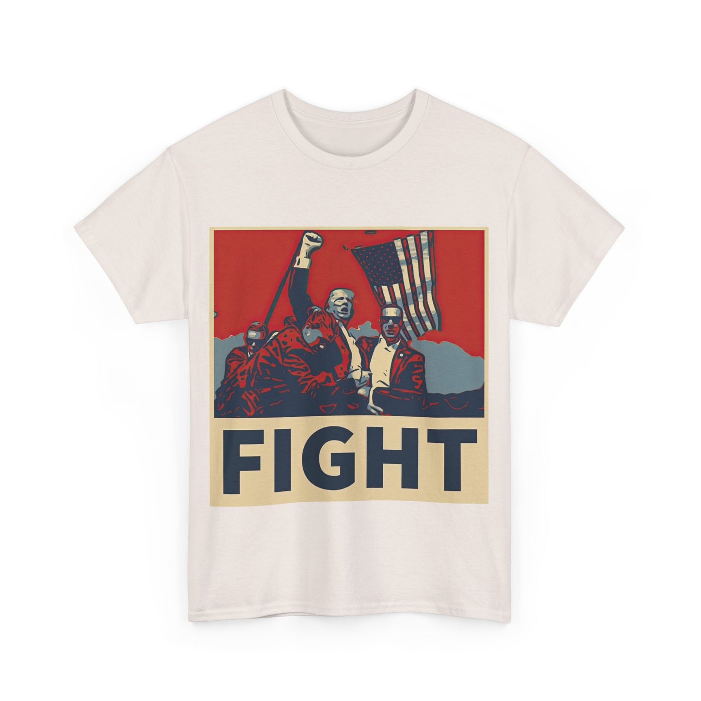 This image shows a light grey, unisex, heavy cotton t-shirt with a graphic design on the front. The design features a stylized, poster-like illustration of former President Donald Trump raising his fist and standing in front of an American flag. The word “FIGHT” is prominently displayed at the bottom of the illustration in bold capital letters. The graphic uses a color palette reminiscent of red, white, and blue, contributing to a patriotic theme. The t-shirt is displayed on a plain white background.