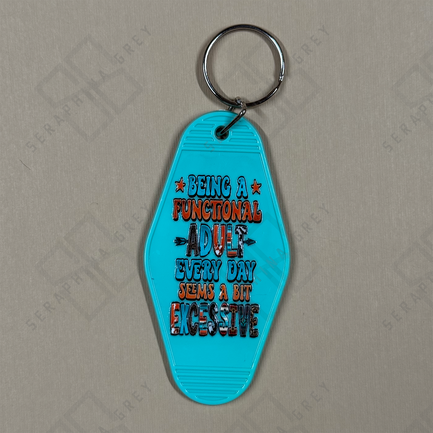 Blue keychain with humorous text being a functional adult every day seems excessive. 