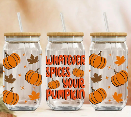 Three 16 oz glass tumblers with bamboo lids and reusable straws, featuring a fun autumn design. The middle tumbler displays the phrase “Whatever Spices Your Pumpkin” in bold, orange lettering with pumpkins and fall leaves surrounding it. The two outer tumblers are decorated with pumpkins, stars, and leaves in orange and brown, creating a cozy fall vibe. Perfect for seasonal beverages.