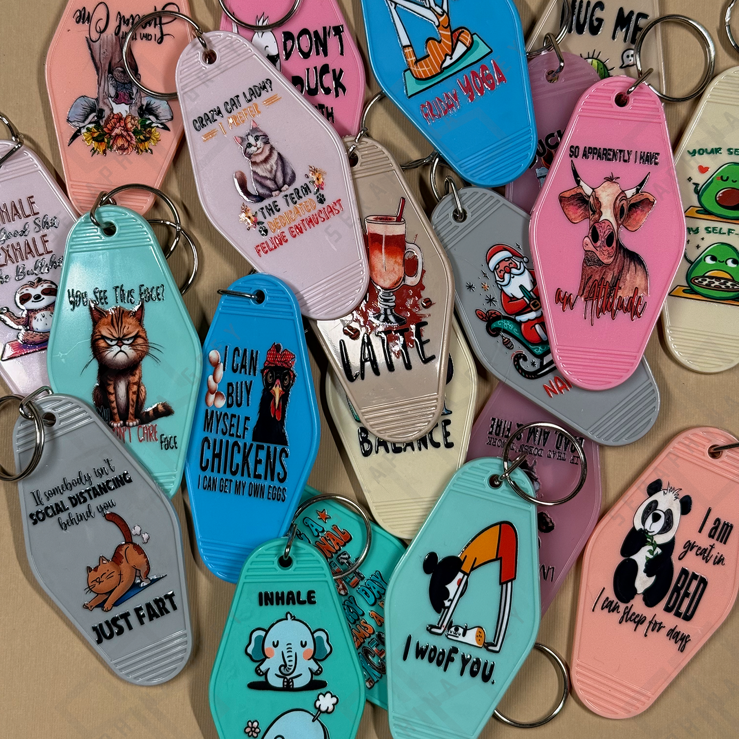 Collection of colorful keychains with various designs on a beige background