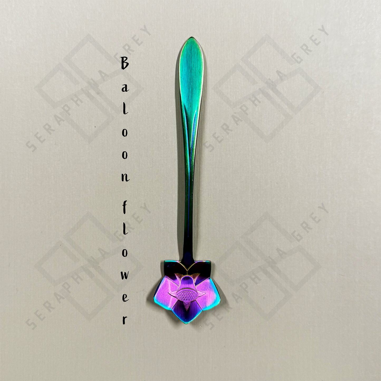 Rainbow Spoon with a balloon floral design on a branded background