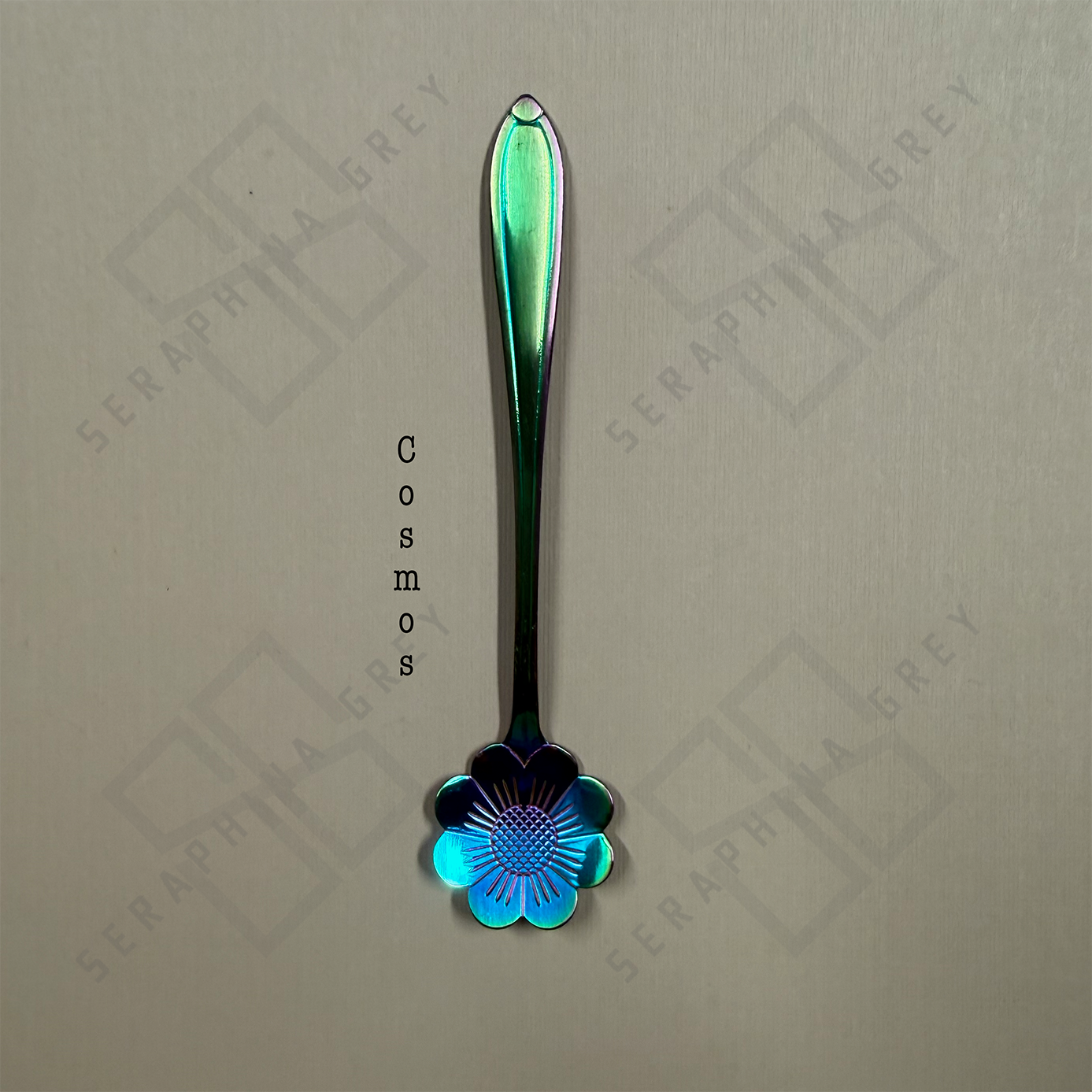 Rainbow Spoon with cosmos floral design on a branded background