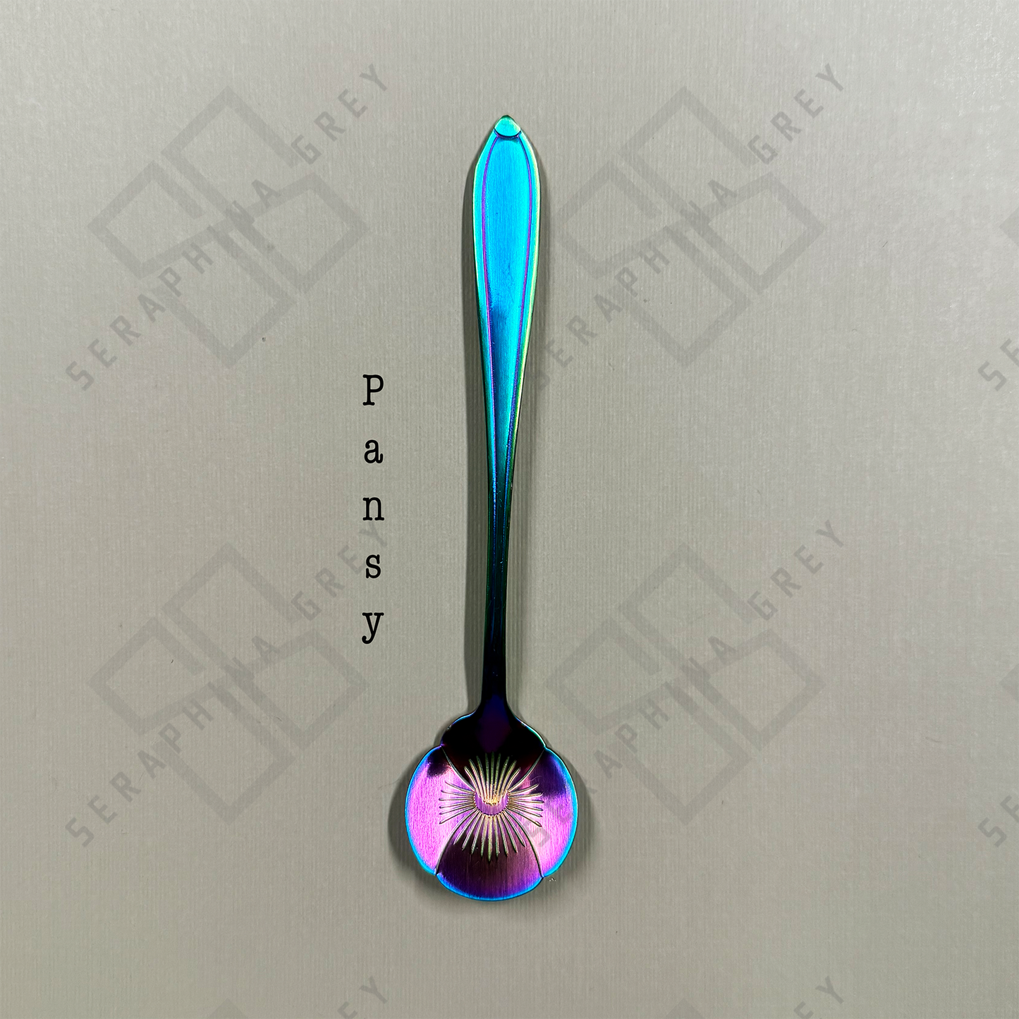 Rainbow Spoon with pansy floral design on a branded background