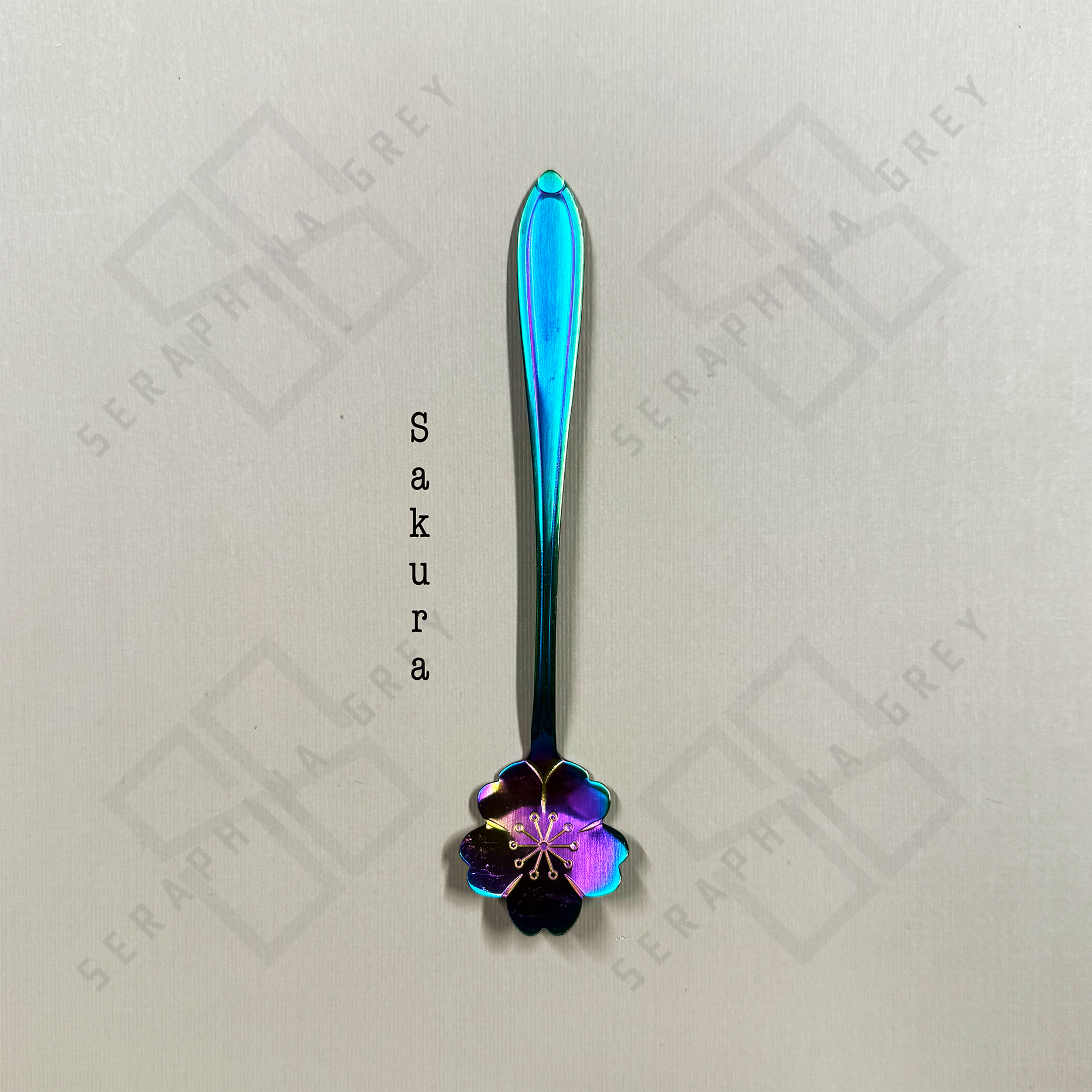 Rainbow Spoon with sakura floral design on a branded background