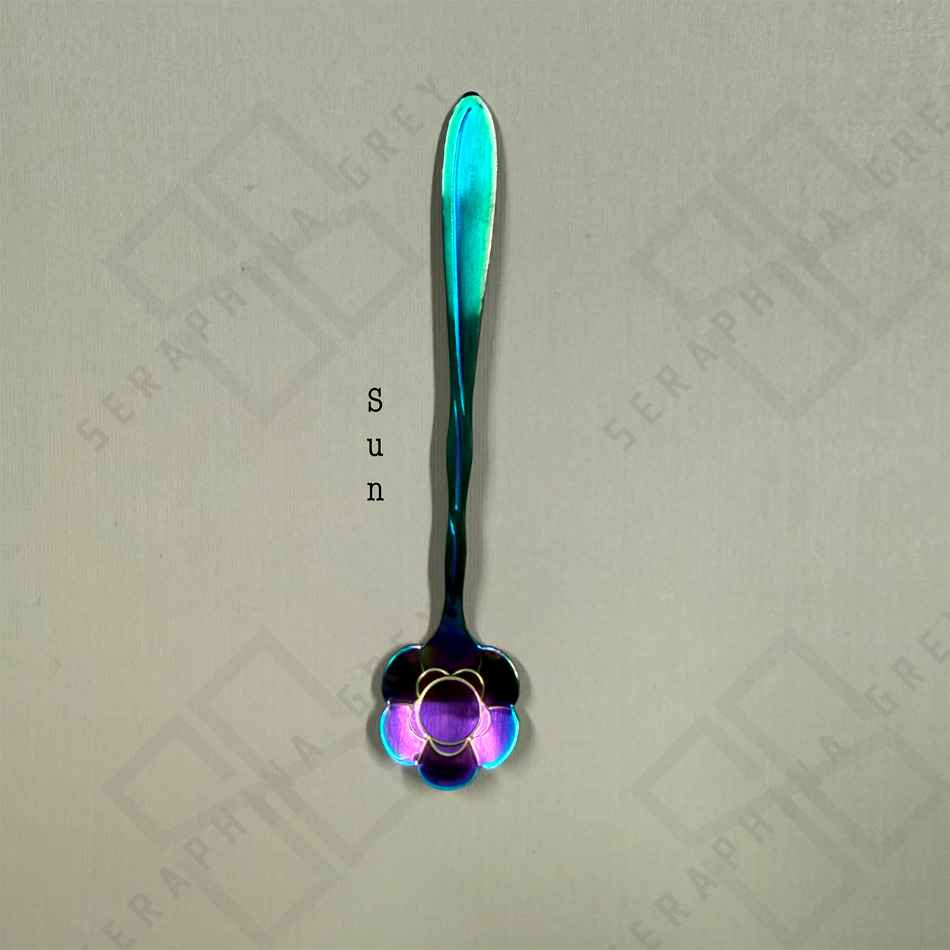 Rainbow Spoon with sun floral design on a branded background
