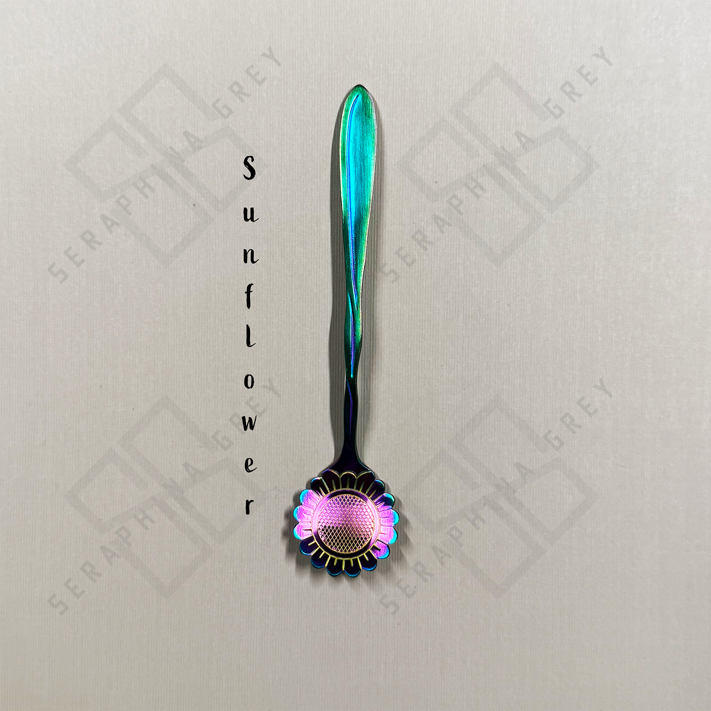 Rainbow Spoon with sunflower floral design on a branded background