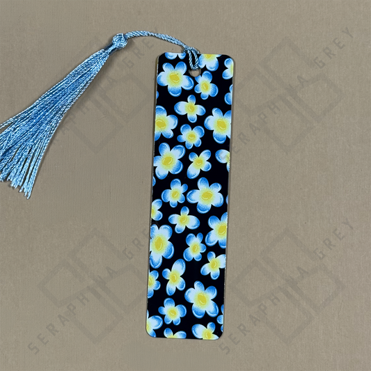 Floral bookmark with blue tassel on a beige background