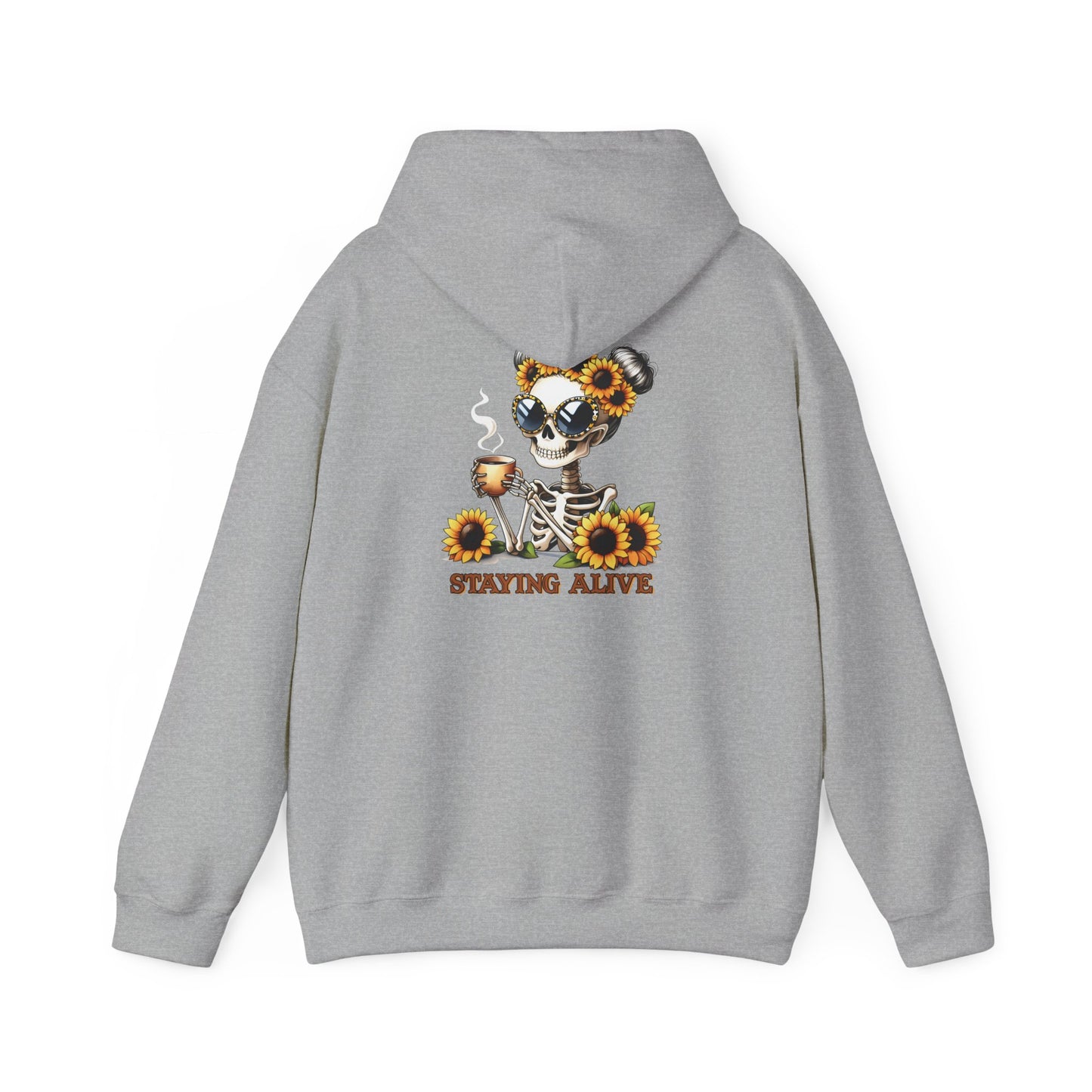 A sport grey pullover hoodie shown from the back, featuring a skeleton wearing oversized sunglasses and sunflower space buns, holding a steaming mug, with “STAYING ALIVE” printed below.