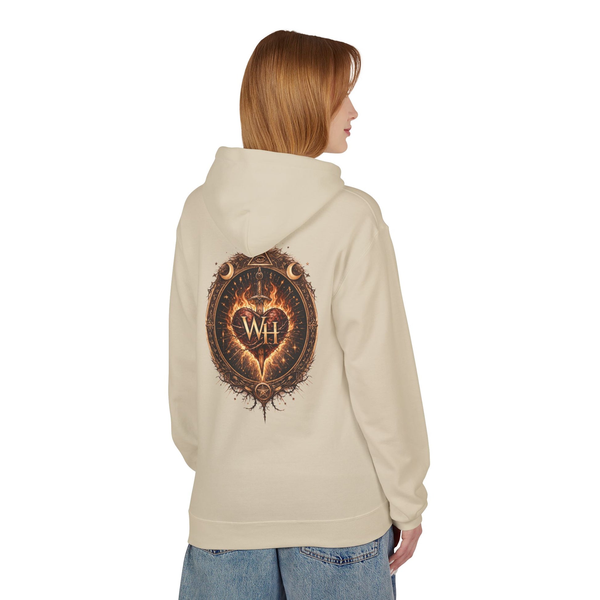 Model wearing a sand-colored pullover hoodie shown from the back, featuring the large circular “Wild Heart” mystical crest with a flaming heart, sword, crescent moons, stars, and “WH” monogram in warm brown and orange tones.