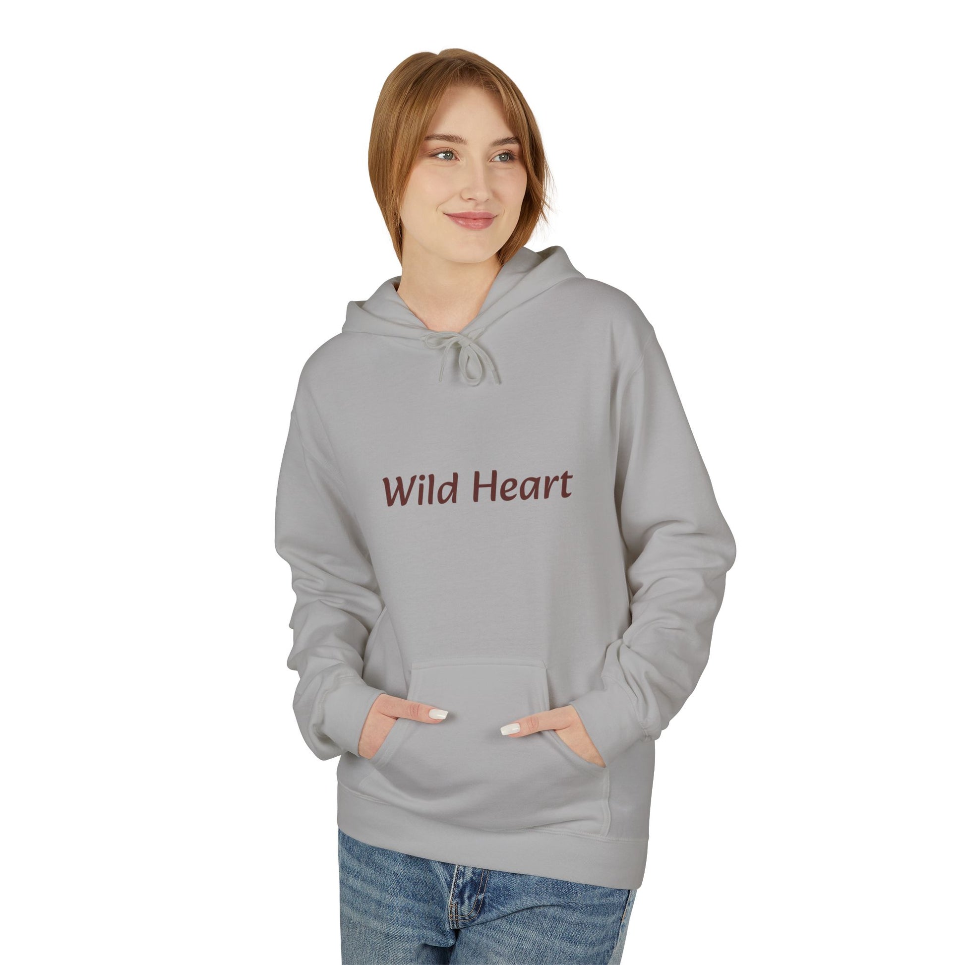 Model wearing a cement-colored pullover hoodie with burgundy “Wild Heart” text across the chest, drawstring hood, and front kangaroo pocket, shown against a white background.