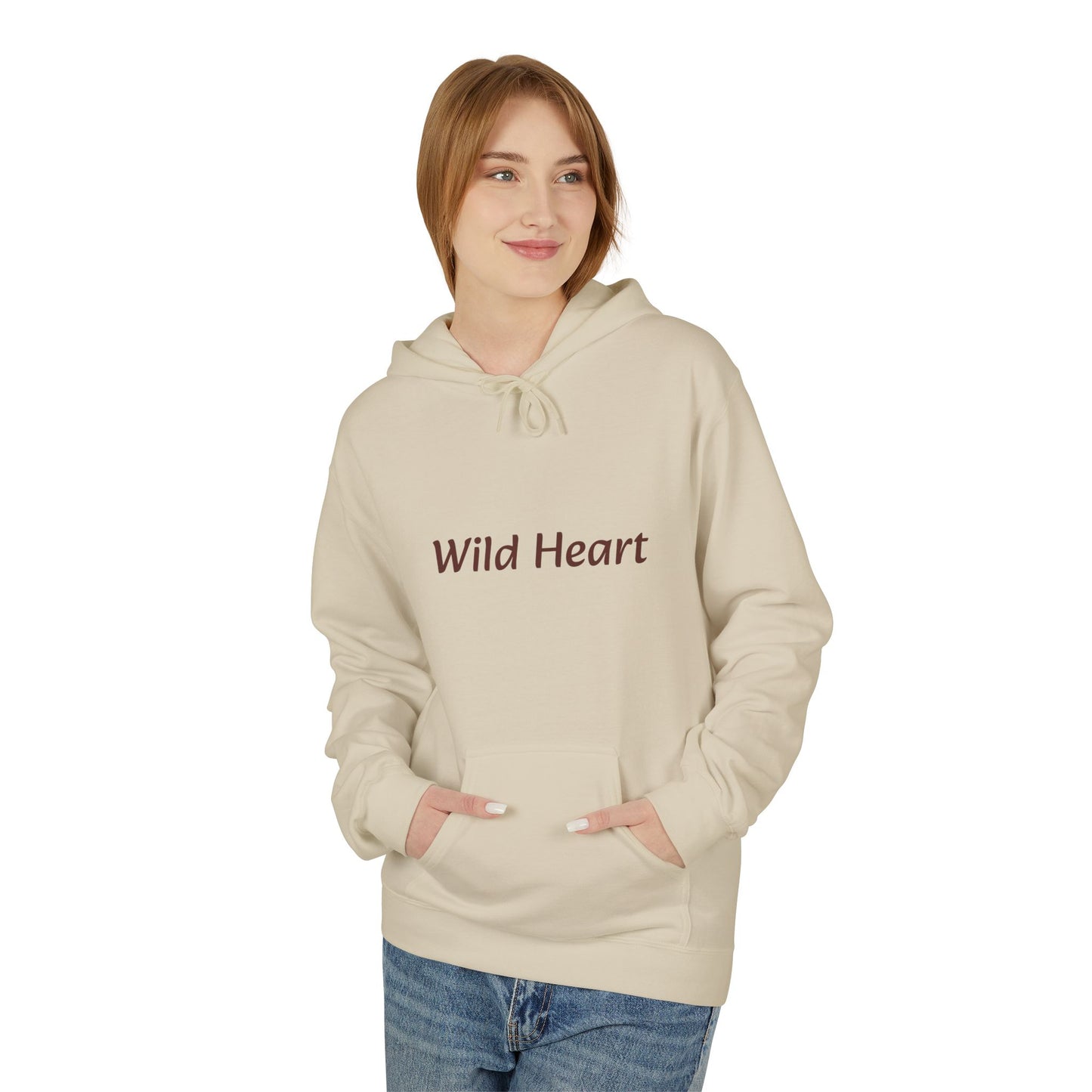 Model wearing a sand-colored pullover hoodie with burgundy “Wild Heart” text across the chest, drawstring hood, and front kangaroo pocket, shown against a white background.
