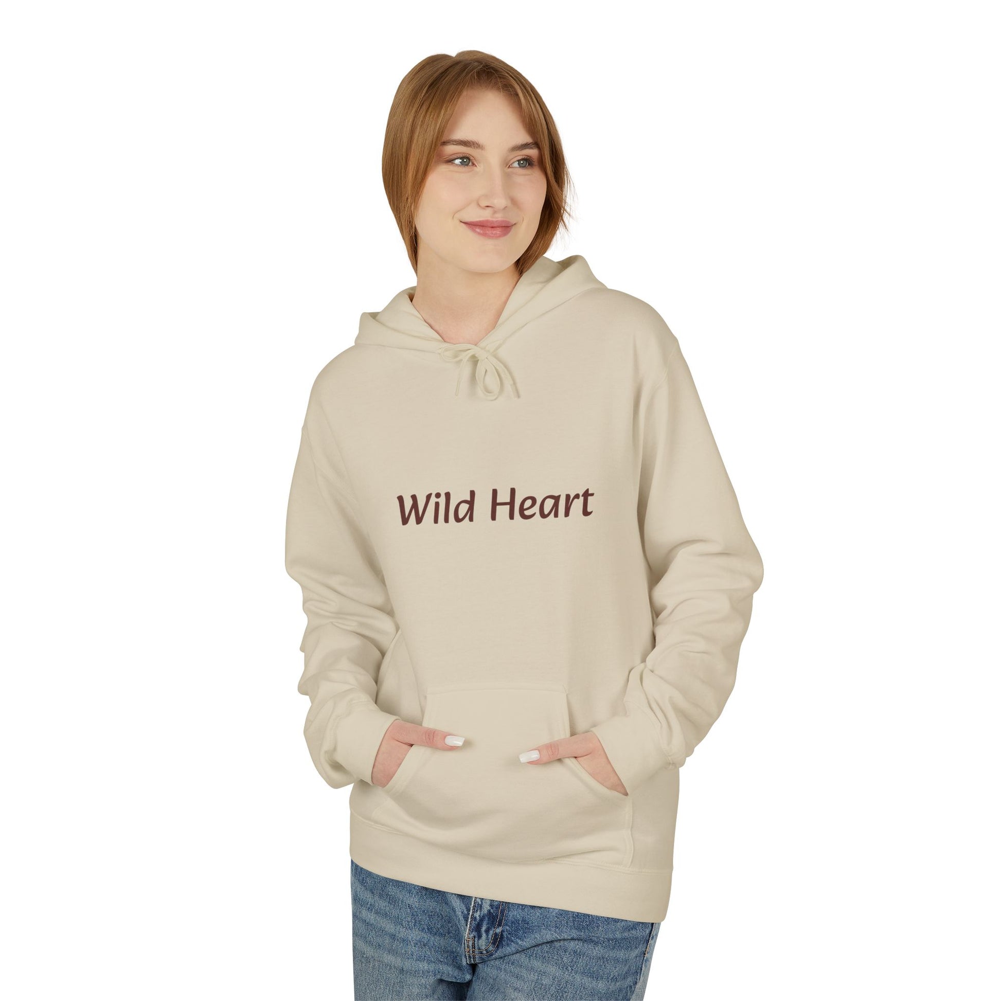 Model wearing a sand-colored pullover hoodie with burgundy “Wild Heart” text across the chest, drawstring hood, and front kangaroo pocket, shown against a white background.