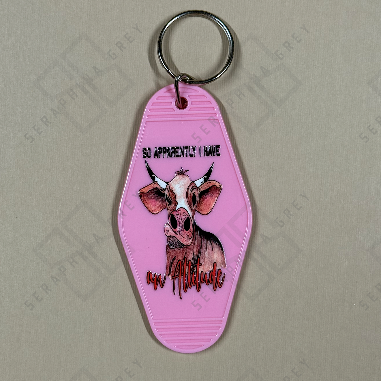 Pink keychain with cow illustration and text so apparently i have an attitude