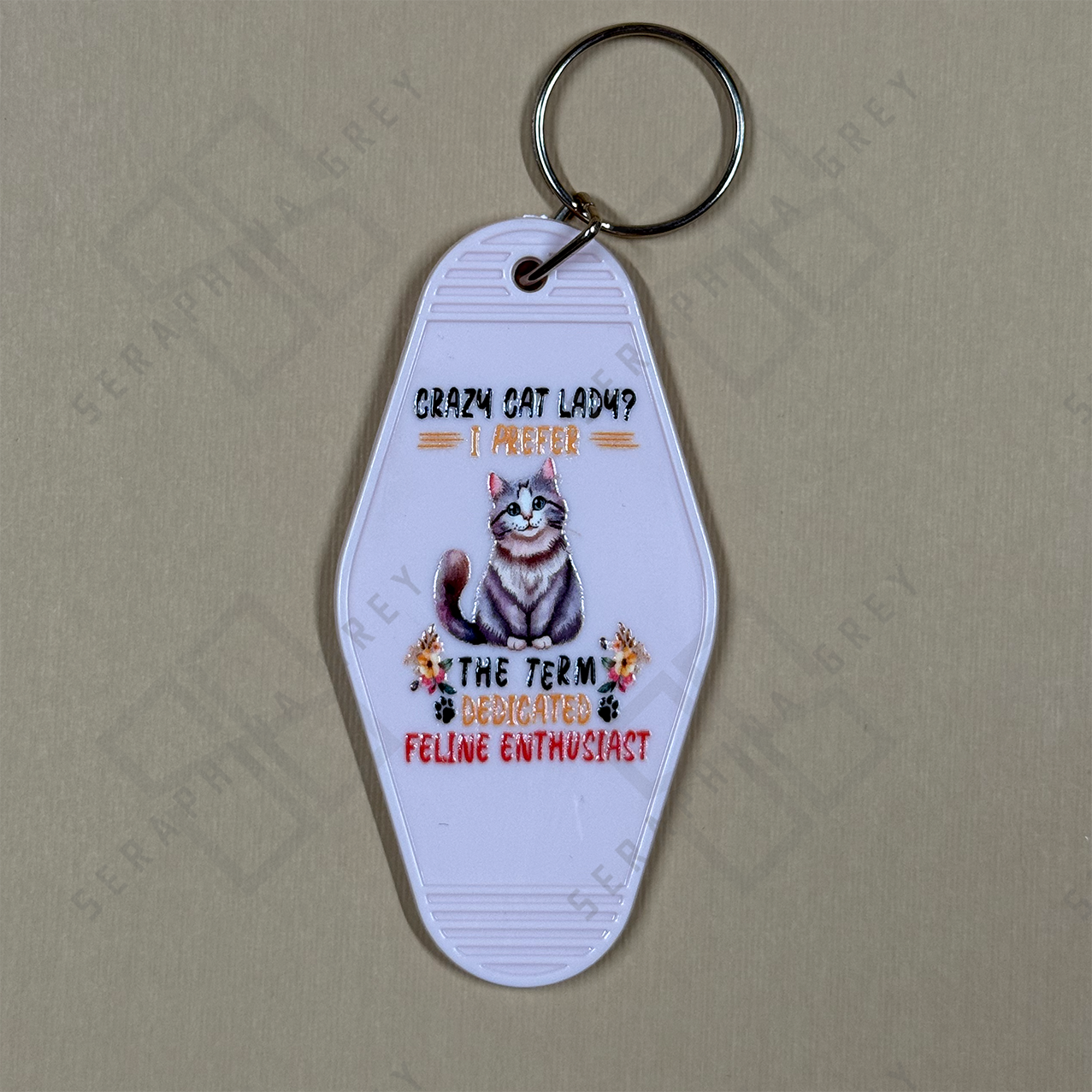 Keychain with a cat illustration and text Crazy cat lady? i prefer dedicated feline enthusiast.