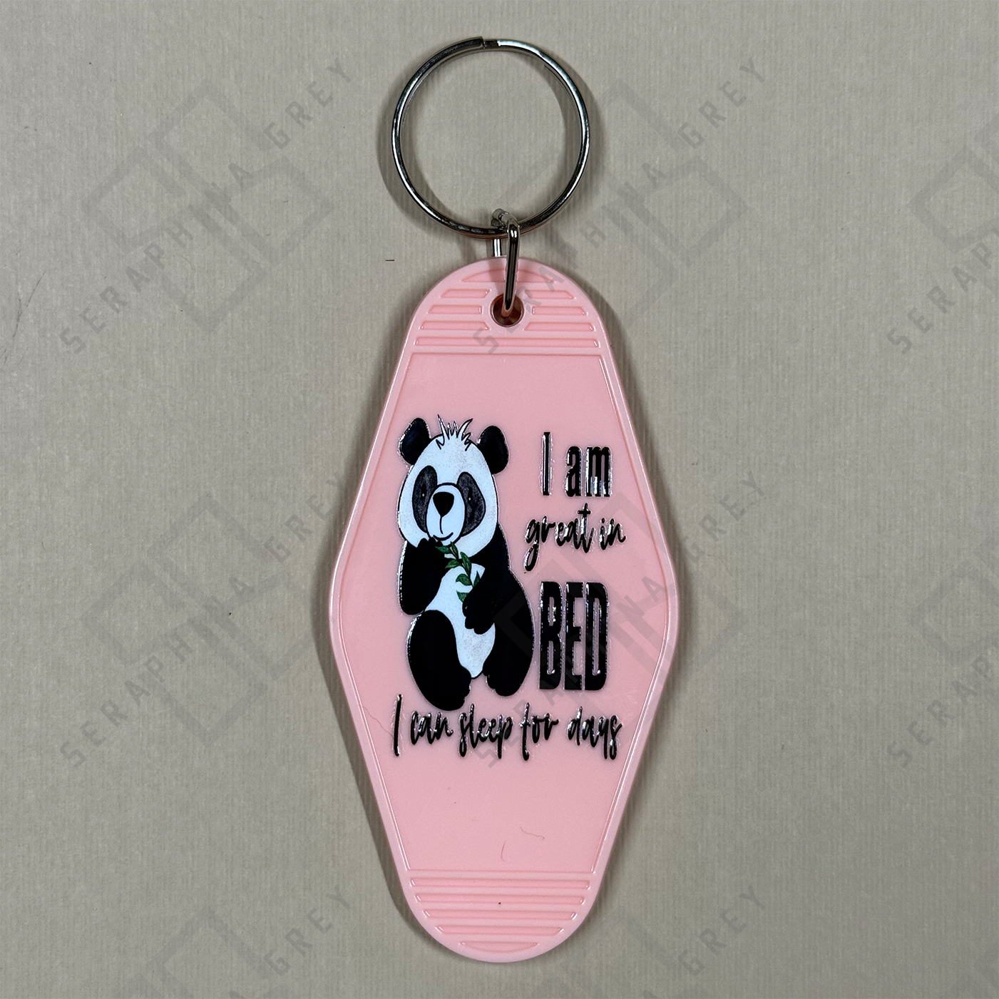 Pink keychain with panda design and text I am good in bed... I can sleep for days.