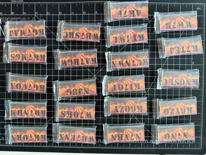 Personalized amateur-radio call-sign pieces arranged in a batch