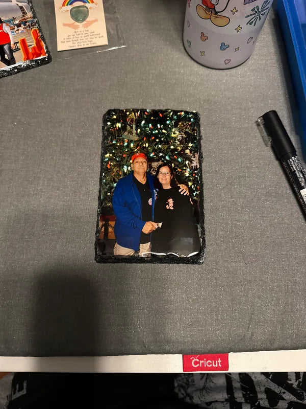 Finished photo slate showing a couple beside a Christmas tree
