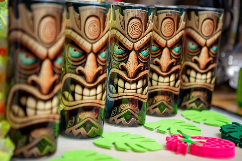 Finished tiki-design tumblers arranged together